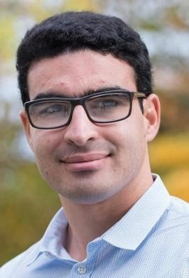 Mohamed Farid standing outdoors, wearing glasses