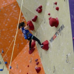 Michelle Ward Caton competes on a climbing wall at the national adaptive climbing competition