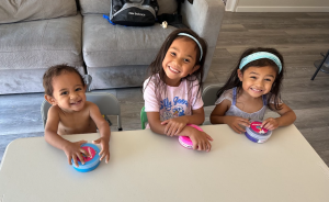 Amari, Iliana, and Malaya Gonzales sitting together at the table
